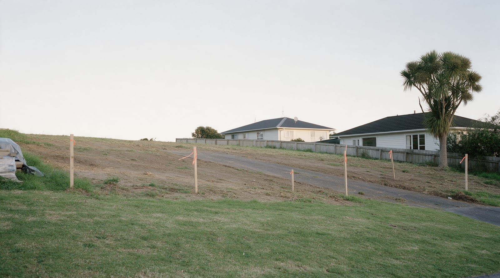 Cleared residential section with survey pegs before construction